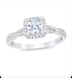 a cushion cut diamond ring with pave set shoulders