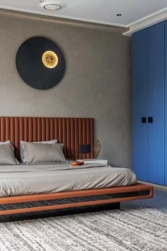 a bedroom with a large bed and blue cupboards