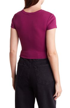 Corset-style seams add structure to a cropped length baby tee that features cap sleeves and rib knit construction. Crewneck Cap sleeves 58% Organic Cotton, 38% Recycled Polyester, 4% Spandex Machine wash, tumble dry Imported Model stats: 5'10" height, 32" bust, 25" waist, 36" hip. Model is wearing size S Fitted Ribbed Cropped T-shirt For Spring, Ribbed Fitted Cropped T-shirt For Spring, Basic Solid Cropped T-shirt With Ribbed Detail, Basic Cropped Elastane Tops, Fitted Short Sleeve Top With Ribbed Neckline For Summer, Fitted Ribbed Basic Cropped T-shirt, Fitted Ribbed Cropped T-shirt, Fitted Ribbed Cropped T-shirt Basic Style, Ribbed Fitted Cropped T-shirt