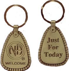 two metal key chains with the words welcome and just for today written on them,