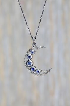 blue sapphire diamond moon crescent moon half moon gift for her Real Sapphire and Diamond Navy Blue Gemstone Valentine's Day Welcome to Nadean Designs This is a large genuine blue sapphire faceted gemstone moon with genuine pave diamonds. The Blue Sapphires are rose cut faceted and bezel set in oxidized sterling .925 silver. SAPPHIRE MOON PENDANT SPECS: Diamond weight .5 cttw Sapphire weight cttw .89 Oxidized sterling silver .925 DIMENSIONS OF MOON: height 28mm x width 8.2mm x thickness 4mm LENG Fine Jewelry Diamond Moon Phase, Fine Jewelry With Sapphire And Single Cut Diamonds, Tanzanite Necklaces With Diamond Accents As Gift, Sapphire Pendant With Single Cut Diamonds, Crescent Rose Cut Diamond Jewelry Gift, Moon Shaped Rose Cut Diamond Jewelry Gift, Crescent Shaped Rose Cut Diamond Jewelry Gift, Blue Sapphire Jewelry With Single-cut Diamonds, Fine Jewelry With Rose Cut Diamonds And Tanzanite