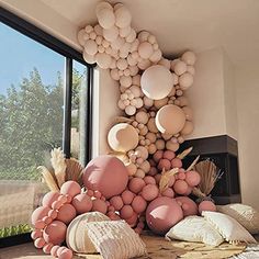 balloons and other items are arranged on the floor in front of a large window, near a fireplace