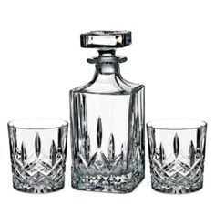 three glasses and a decanter on a white background