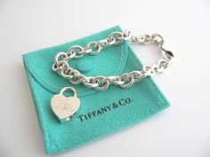 Offered for sale is a wonderful and rare Tiffany and Co. Sterling Silver Notes Heart Padlock bracelet. The piece is made from substantial and bright Tiffany silver, and yet retains a very feminine feel to it. Attached to its very substantial Tiffany Silver charm bracelet is a Heart padlock charm with "Tiffany & Co" written in beautiful script. The Notes Heart padlock charm can be removed from the bracelet, and thus can be used as a pendant on a necklace or placed on another charm bracelet! S Padlock Bracelet, Tiffany Bracelets, Heart Padlocks, Gift Love, Silver Charm Bracelet, Tiffany And Co, Bracelet Bangle, Tiffany Heart, Heart Charm Bracelet