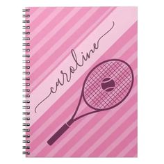 a pink spiral notebook with a tennis racket on the front and name written in cursive writing