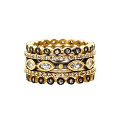 three gold rings with black and white diamonds