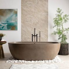 a bathtub sitting on top of a white floor next to a potted plant