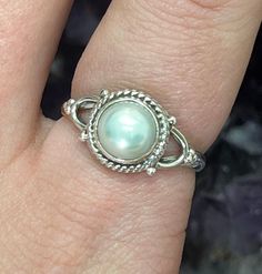 This listing is for a single 925 Wishbone Design Pearl Sterling Silver Ring. A few options are pictured to show the natural variation in the stone. Mother Of Pearl comes from a mollusk shell that produces the inner layer of shell. Usually, the material is strong and has a white hue. It is known for its iridescent rainbow that shows different colors depending on the angle. Mother Of Pearl is the same material as the outer coating of Pearls. Mother Of Pearl helps to focus ones attention to bring t Untreated Round Sterling Silver Jewelry, White Pearl Sterling Silver Ring, White Sterling Silver Pearl Ring, Fine Jewelry Sterling Silver Pearl Ring With Oval Shape, Oval Sterling Silver Pearl Ring, Fine Jewelry Oval Pearl Ring In Sterling Silver, Oval Sterling Silver Pearl Ring In Fine Jewelry Style, Heirloom Sterling Silver Jewelry With Round Stone, Silver Pearl Ring With Gemstone In Sterling Silver