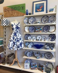 a display in a store filled with blue and white plates, bowls and vases