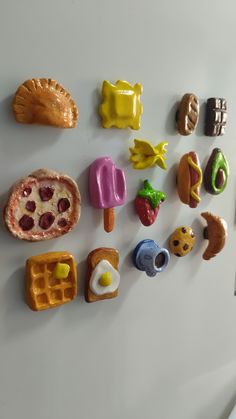 there are many different types of food on the refrigerator magnets that look like they were made out of play doughnuts