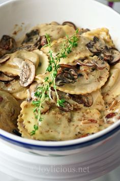 a white bowl filled with pasta and mushrooms