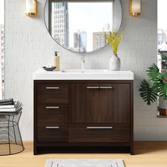 a bathroom vanity with a round mirror above it and a rug on the floor next to it