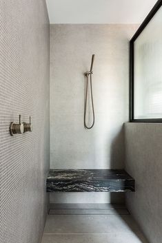 a bathroom with a bench and shower head