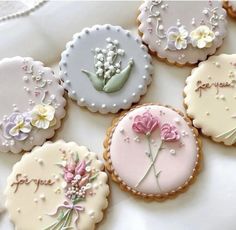 several decorated cookies with flowers on them