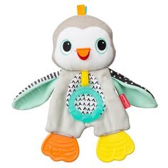 a small stuffed penguin with an orange beak and yellow legs, wearing a pacifier