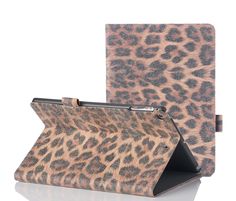 an animal print ipad case sitting on top of a white table next to a black tablet