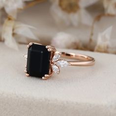 Embrace the enchanting allure of our Emerald Cut Black Onyx Diamond Ring, meticulously crafted in lustrous 14K rose gold. Onyx Rings Women, Onyx Diamond Ring, Black Onyx Engagement Ring, Onyx Engagement Ring, Side Stone Engagement Ring, Black Onyx Ring, Moissanite Jewelry, Onyx Ring, Elegant Ring