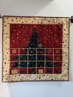 a wall hanging with a christmas tree on it