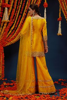 Cadmium yellow kurta with gota embroidery. Comes with sharara and a dupatta.
Components: 3
Pattern: Embroidered
Type Of Work: Gota
Neckline: Boat Neck
Sleeve Type: Three quarter
Fabric: Kurta : Dupion, Sharara : Dupion and Net, Dupatta : Net, Lining : Shantoon
Color: Yellow
Other Details: 
Closure : Side zip
Occasion: Mehendi and Haldi - Aza Fashions Gota Embroidery, Cadmium Yellow, Yellow Kurta, Kurta Sharara Set, Kurta Sharara, Types Of Work, Sharara Set, Net Dupatta, Set For Women