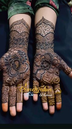 two hands with henna tattoos on them, one is showing the intricate design and the other has flowers