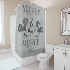 a bathroom with mickey and minnie mouse shower curtain