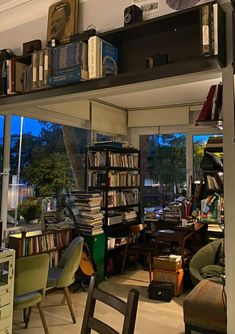 a room filled with lots of books and furniture