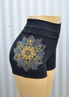 Crystal Mandala High Waisted Hot Shorts - Glow in the Dark Sacred Geometry Yoga ShortsThese comfortable and stylish black high waisted hot shorts features a glow in the dark and metallic gold screen print of my hand drawn Crystal Mandala. This original design also includes a metallic gold print of my simple Metatron's Cube, which I made specifically to layer and align with the geometry of my more detailed Crystal Mandala. This gold layer also includes the Platonic Solids and the Seed of Life in Black Short Length Rave Bottoms, Rave Style Festival Shorts, Fitted Rave Shorts, Stretch Rave Shorts, Fitted Rave Bottoms With Built-in Shorts, Crystal Mandala, Metatron's Cube, Platonic Solid, Metatrons Cube