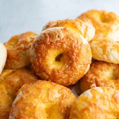 a pile of doughnuts sitting on top of a table