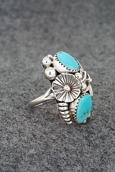 This turquoise and sterling silver ring was made by Navajo silversmith Max Calladitto. The inside of the band is signed and stamped sterling.Size: 5Length: 1 1/8"Width: 5/8"Free shipping on all orders! We ship with USPS and always include tracking. All orders ship within a day of payment.Returns are accepted up to 30 days after you receive your order. Just send us a message. Our shop offers cash back or store credit. The item must be returned in new condition. Untreated Southwestern Turquoise Ring For Anniversary, Southwestern Sterling Silver Turquoise Ring For Anniversary, Southwestern Turquoise Rings Stamped 925, Southwestern Style Turquoise Ring Stamped 925, Southwestern Style Stamped 925 Turquoise Ring, Collectible Southwestern Turquoise Ring Stamped 925, Sterling Silver Turquoise Rings With Concho Detail, Sterling Silver Turquoise Ring With Concho, Southwestern Turquoise Ring In Sterling Silver