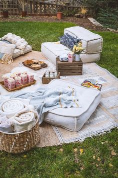 an outdoor picnic is set up on the grass