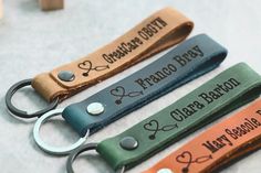 three leather keychains with personalized names on them