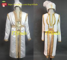 two white and gold costumes on mannequins