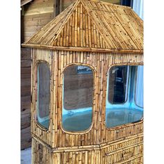 a bamboo gazebo with three windows on the side