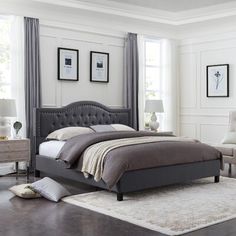 a bedroom with white walls and gray furniture