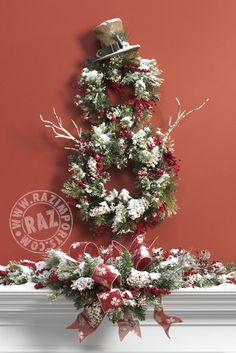 a christmas wreath on top of a mantel