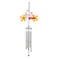 a wind chime hanging from the side of a white wall with an orange and yellow design on it