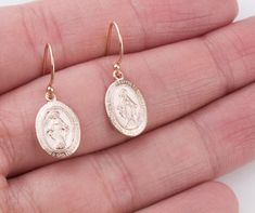 Dainty Oval Virgin Mary earrings in sterling silver, 14K gold filled and rose gold filled. Perfect for a Easter gift! Super dainty and wonderful for everyday wear! EARRING DESCRIPTION: - Oval Virgin Mary charm 14mm - sterling silver, gold filled and rose gold filled - Ear wires in sterling silver, gold filled and rose gold filled - Comes with plastic ear backs for a secure fit - Handmade and packaged beautifully for you! - - - - - - - - - - - - - - - - - - - - MATERIALS: - 14K Gold Filled: Gold Tarnish Resistant Sterling Silver Oval Earrings, Oval 14k Gold-filled Jewelry For Anniversary, 14k Gold-filled Oval Earrings, Nickel-free Rose Gold Earrings Gift, Hallmarked Oval Rose Gold Earrings, Rose Gold Nickel-free Earrings For Gift, Rose Gold 14k Gold-filled Earrings Gift, Rose Gold 14k Gold Earrings As Gift, Oval Rose Gold Hallmarked Earrings