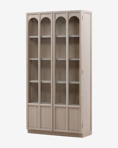 a wooden bookcase with glass doors on the front and bottom shelves in light wood