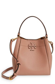 A stacked-T logo appliqué and a line of running stitches detail this pebbled-leather bucket bag that can be slung on the shoulder or across the body. 7 1/2"W x 7 1/2"H x 4 3/4"D. (Interior capacity: small.)
3 1/2" strap drop; 19 3/4" - 23 1/2" convertible strap drop.
1.2lb. Magnetic-snap closure Top shoulder strap; removable crossbody strap Interior wall pockets Unlined Leather Imported Leather Bucket Bag, Leather Bucket, Interior Wall, Wall Pockets, Crossbody Strap, Pebbled Leather, Snap Closure, Bucket Bag, Tory Burch