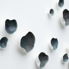 several black and white bowls sitting on top of each other in the shape of hearts