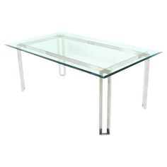 a glass table with metal legs on a white background