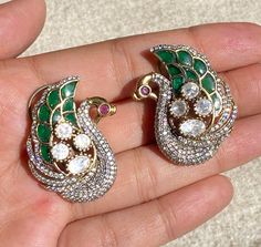 Sabyasachi-inspired Emerald Doublet Polki earrings crafted with precision, they showcase the exquisite charm of Uncut Polki studs, complemented by the brilliance of Moissanite diamonds. Embellished with traditional Jadau Kundan detailing, these earrings capture the essence of Indian craftsmanship and elegance. Elevate your ensemble with the timeless sophistication of these India earrings, a perfect blend of heritage and contemporary style. *𝐏𝐑𝐎𝐃𝐔𝐂𝐓 𝐃𝐄𝐓𝐀𝐈𝐋* * Material: Brass * Platin Intricate Temple Jewelry Earrings With American Diamond, Traditional Peacock Design Earrings For Formal Occasion, American Diamond Temple Jewelry Earrings With Intricate Design, Traditional Bridal Earrings With Meenakari And American Diamond, Traditional American Diamond Meenakari Bridal Earrings, Bollywood Meenakari Earrings For Anniversary, Bollywood Style Meenakari Earrings For Anniversary, Ceremonial Kundan Earrings With Peacock Design, Temple Jewelry Earrings With American Diamond