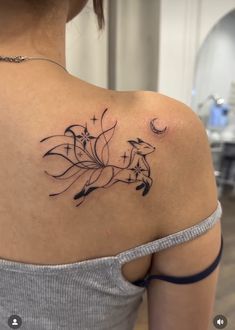 a woman with a tattoo on her back shoulder and the image of two foxes in flight