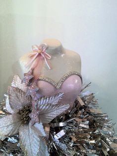 a mannequin is adorned with silver and pink decorations