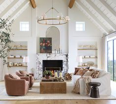 a living room filled with furniture and a fire place in front of a fireplace surrounded by windows