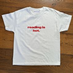 Reading Is Hot White T-Shirt Fast Shipping $25 Lowest I Can Do Custom Deadstock Hit Me With Questions Cute Swear Shirt, Simple Iron On Shirts, Cool Printed Shirts, Fun Baby Tees, Iconic T-shirts, Reading Is Hot Shirt, Cheap Basic Tops With Embroidered Text, Vintage T Shirt Aesthetic, Galentine Tshirt