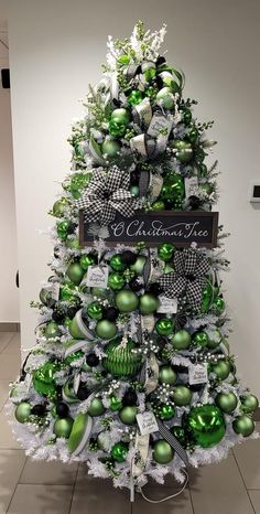 a christmas tree decorated with green and silver ornaments