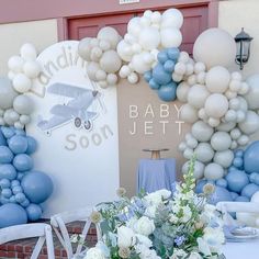 a baby shower is set up with balloons and flowers