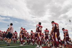 a group of football players standing on top of a field