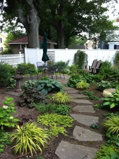 an outdoor patio area with stepping stones and plants